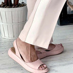 Side view of pink Keliso sandals with stretch back straps.
