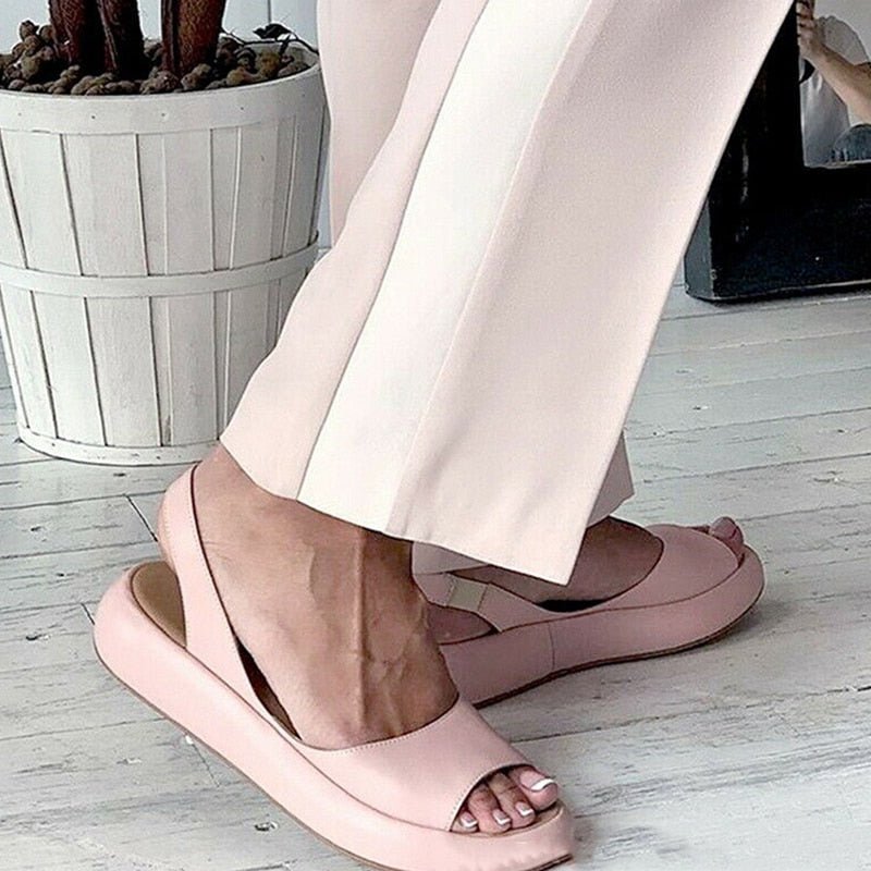 Side view of pink Keliso sandals with stretch back straps.