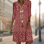 Red floral dress with a V-neck and a fuller gathered hem.