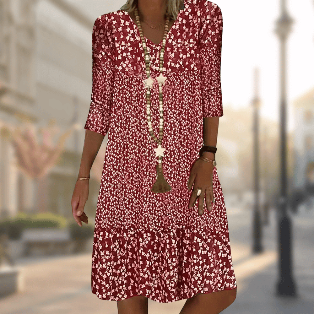 Red floral dress with a V-neck and a fuller gathered hem.