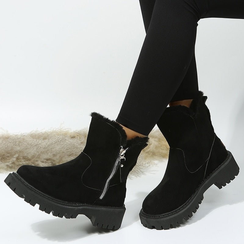 Black Furboots with side zips and chunky lug soles.
