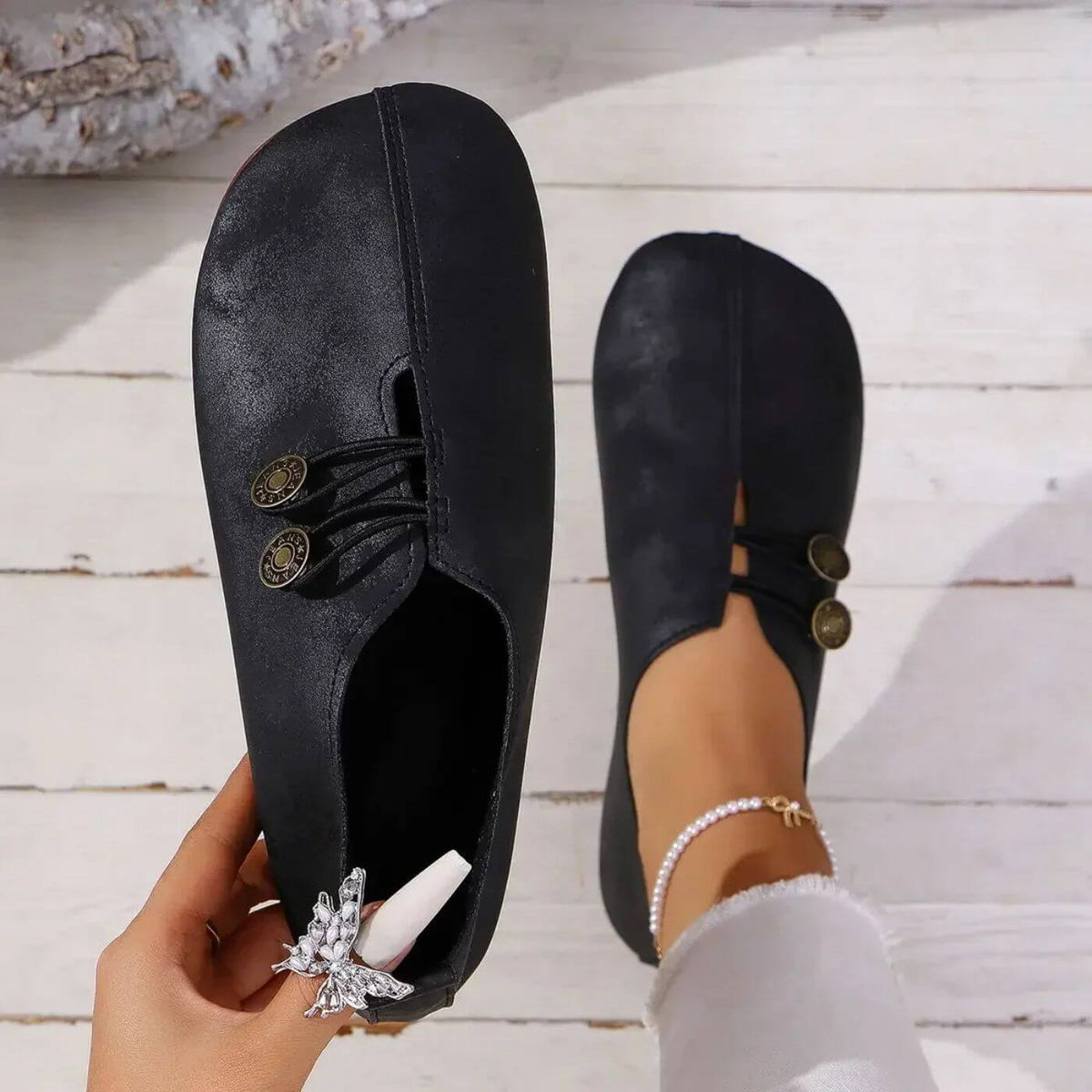 Top view of black slip-on shoes showing their rounded toe shape.