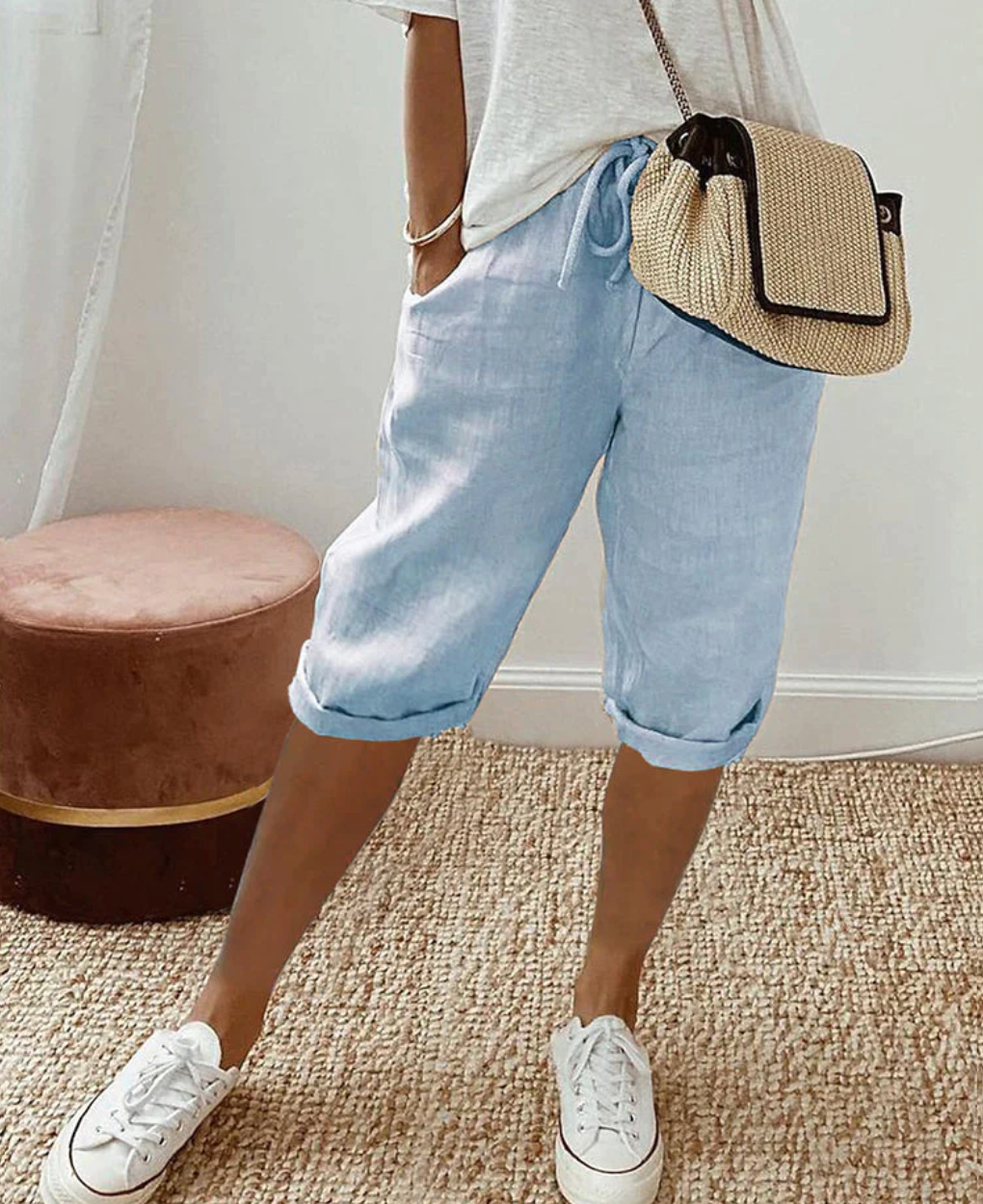 Pale blue shorts with a front drawstring and narrow turned-up hems.