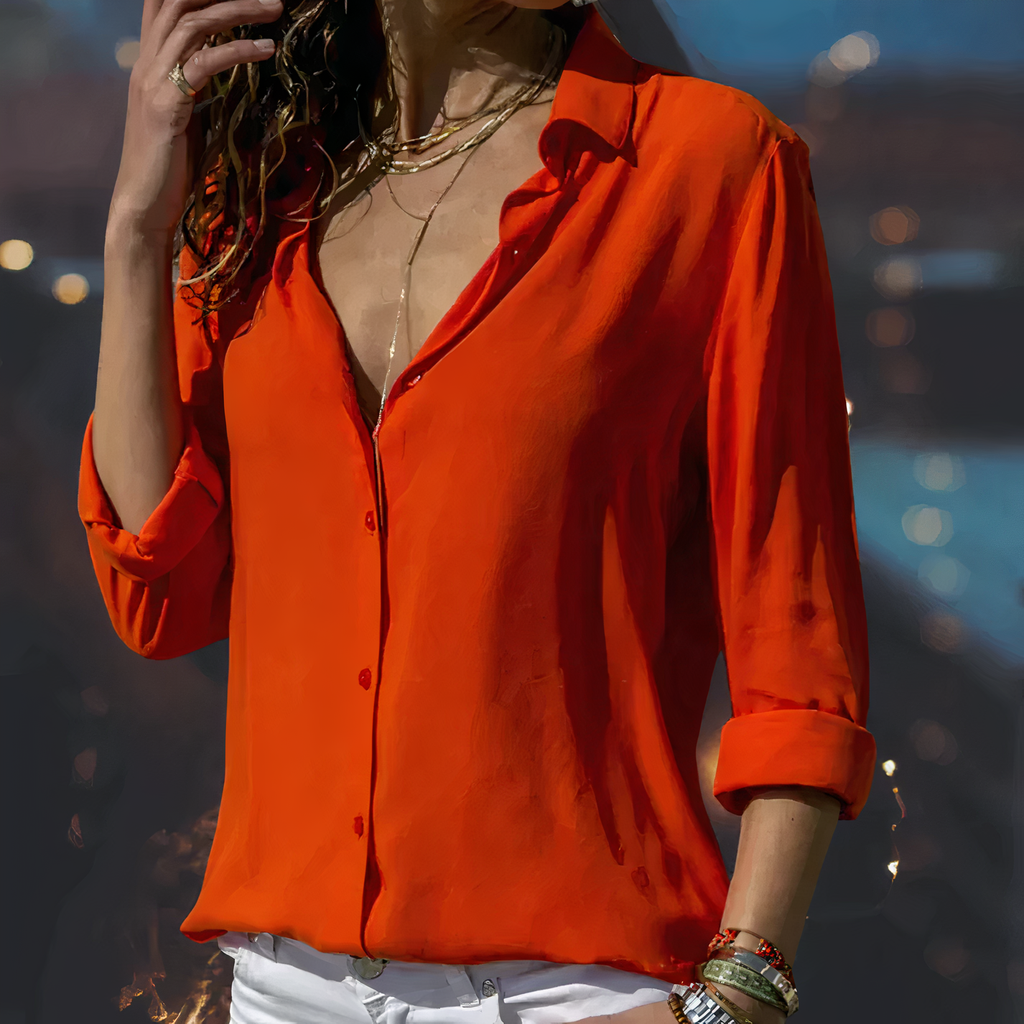 Red-orange blouse with a collar and rolled sleeves.