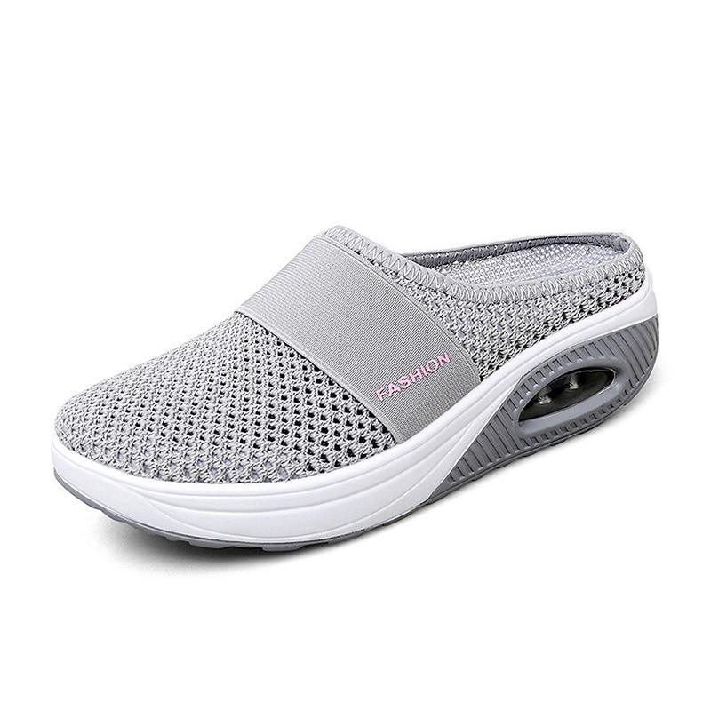 Light grey open-back mesh shoe with a wide front band.