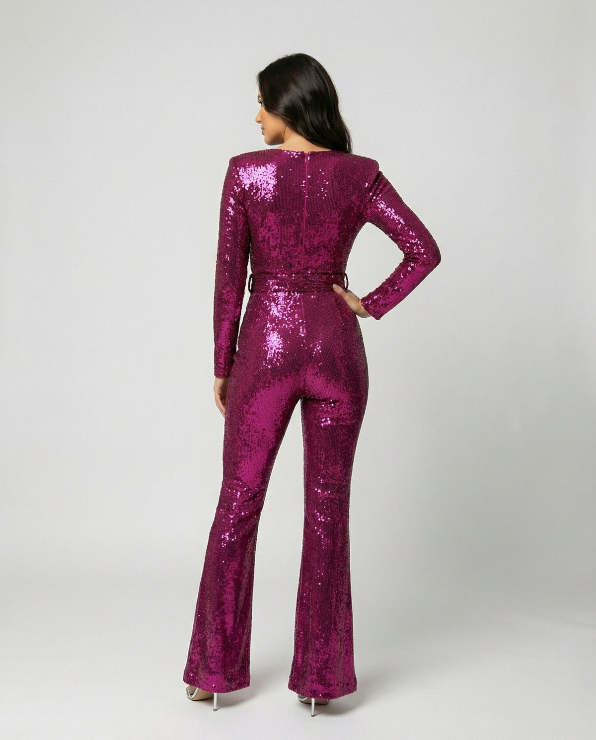 Rear view of the pink sequin jumpsuit with a fitted waist.