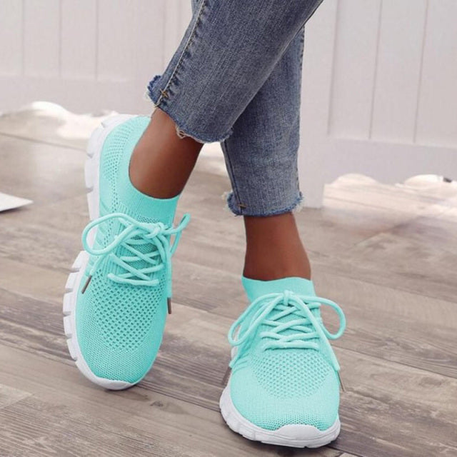 Turquoise-coloured trainers worn with cropped jeans.