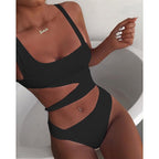 Black swimsuit with shoulder straps and an open waist detail.