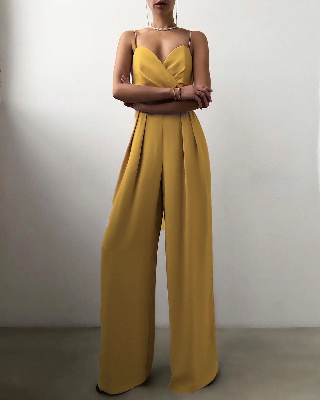 Yellow sleeveless jumpsuit with a folded bodice.