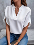 White split-neck blouse with a small stand collar and overlapping short sleeves.
