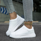 All-white trainers shown together from side and front angles.