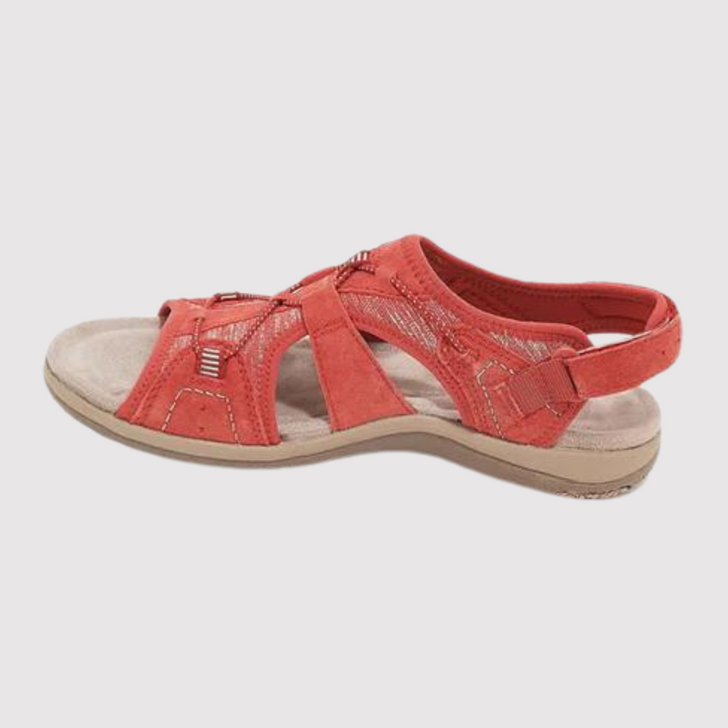 Red sandal with stitched panels and a light-coloured sole.