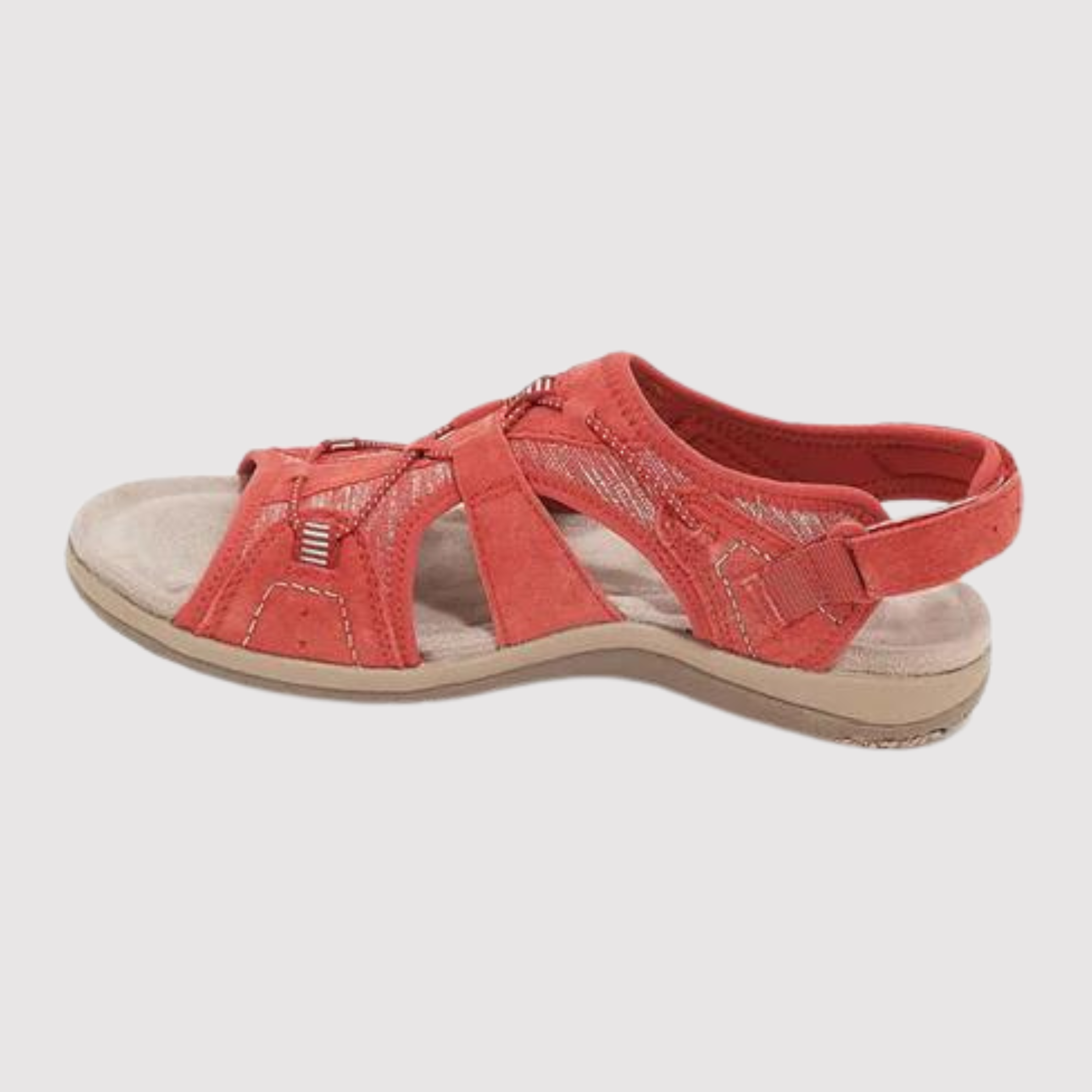 Red sandal with stitched panels and a light-coloured sole.