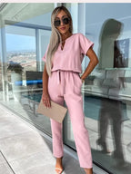 Pink jumpsuit with side pockets and tapered trousers.
