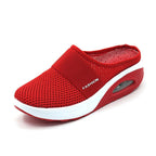 Red mesh mule with a white-edged sole and a wide front band.
