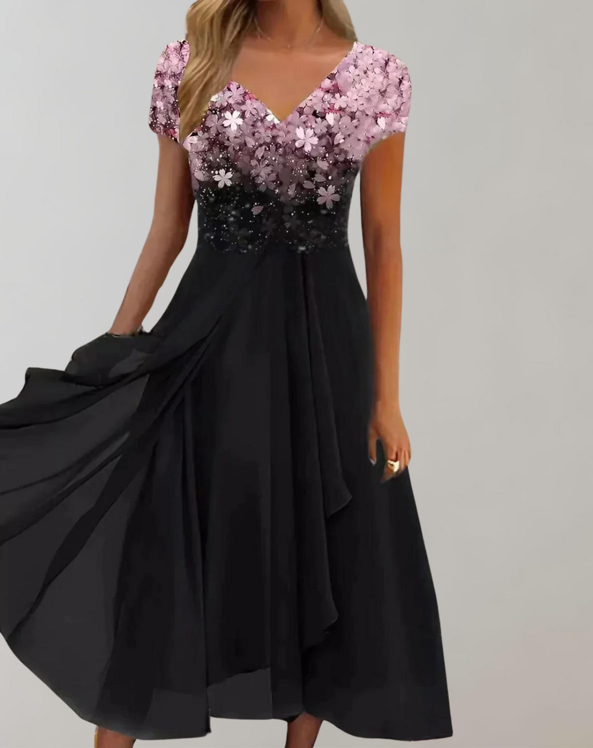 Pink floral short-sleeved bodice above a black skirt.
