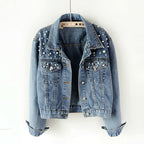 Blue beaded denim jacket hanging with the cuffs turned up.