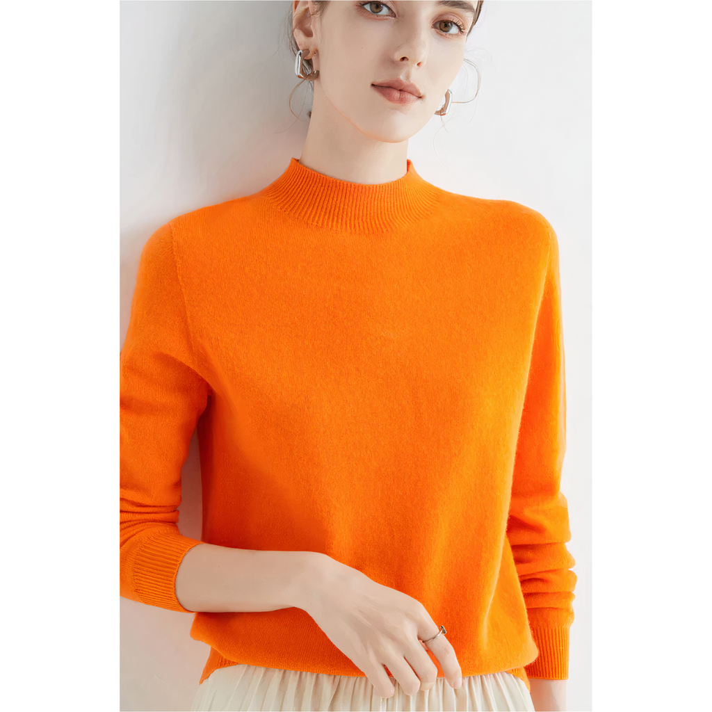 Orange jumper worn with cream trousers.