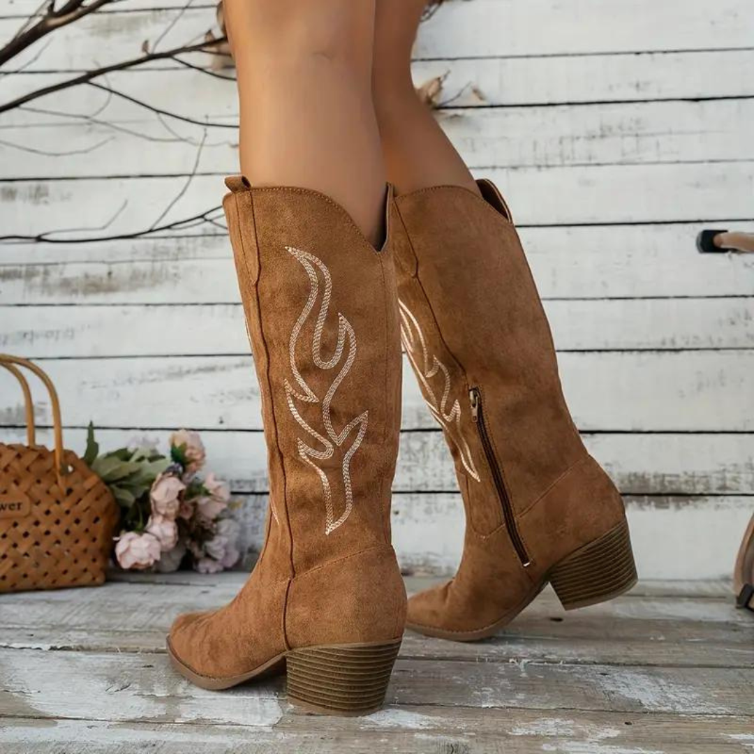 Brown tall western boots showing inner side zips and chunky heels.