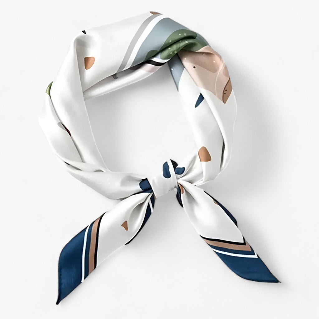 Pale printed scarf with green accents and navy-edged ends.