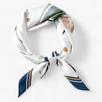 Pale printed scarf with green accents and navy-edged ends.