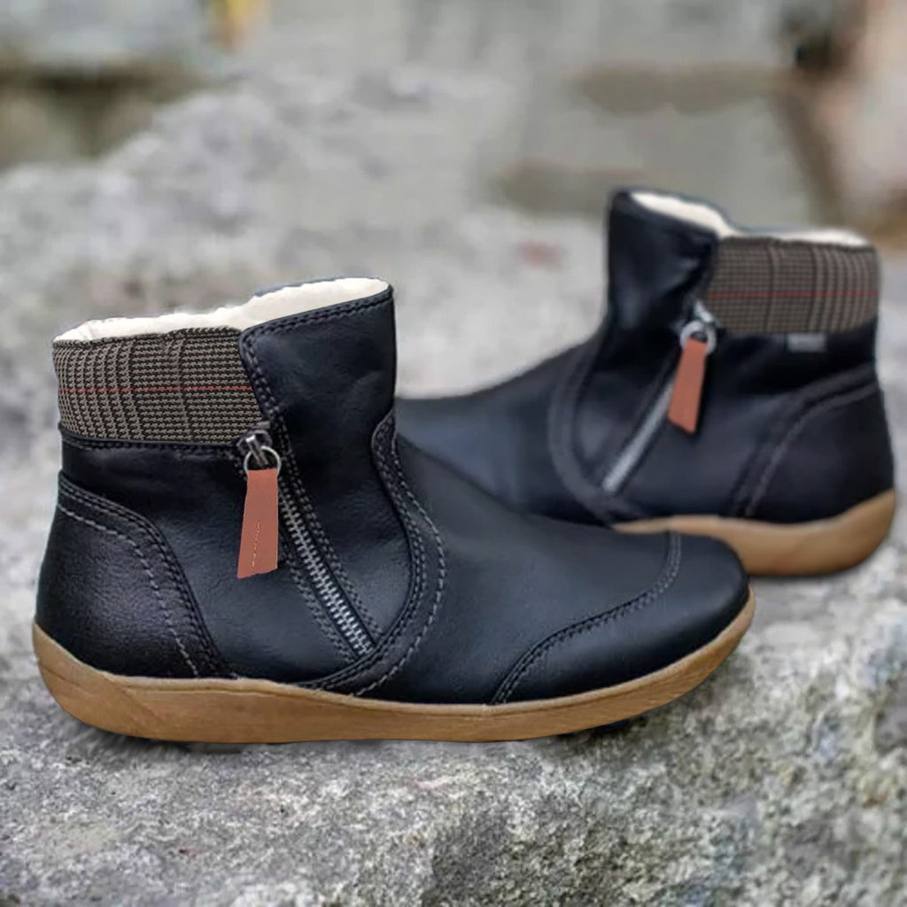 Black ankle boots with side zips and checked fabric around the collars.
