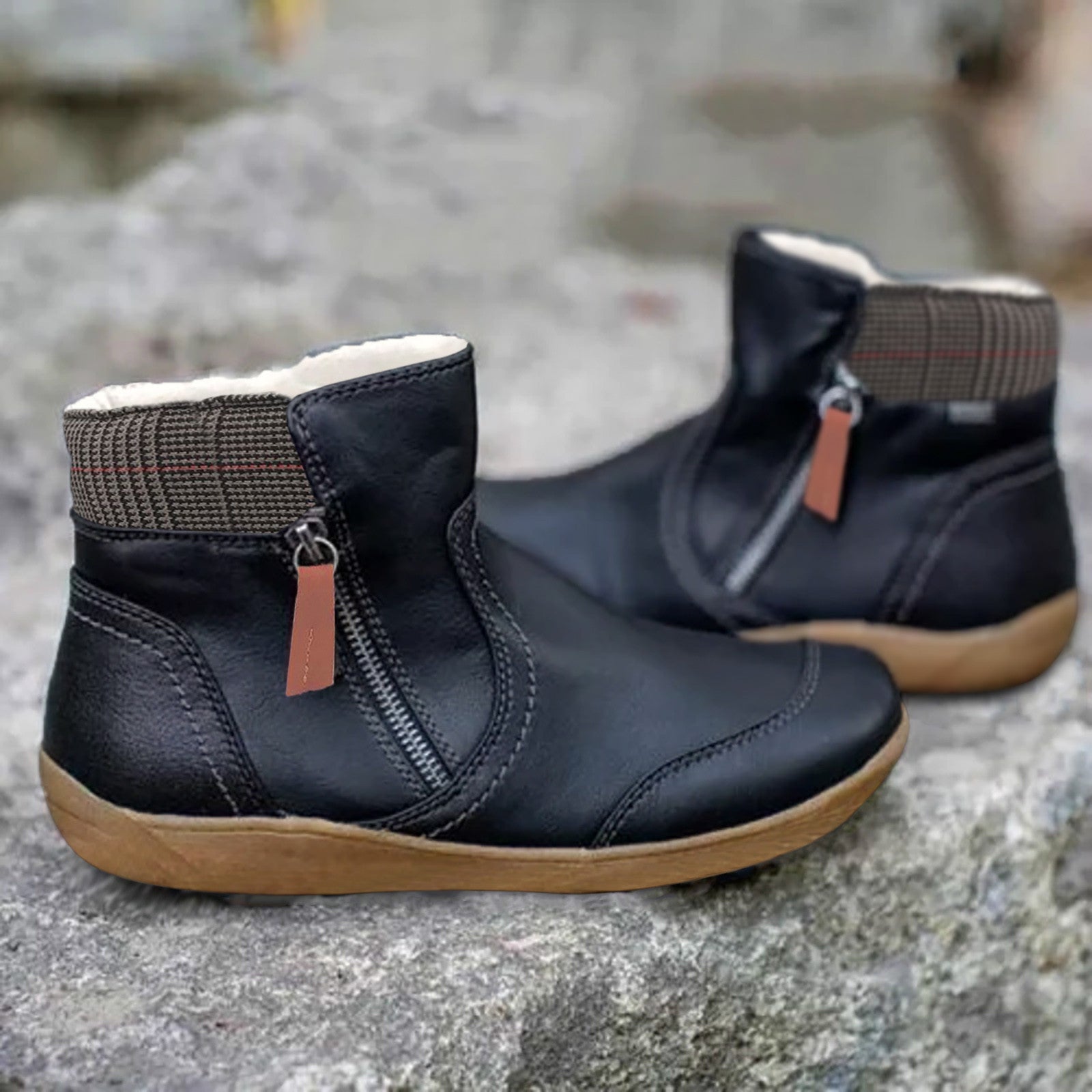 Black ankle boots with side zips and checked fabric around the collars.