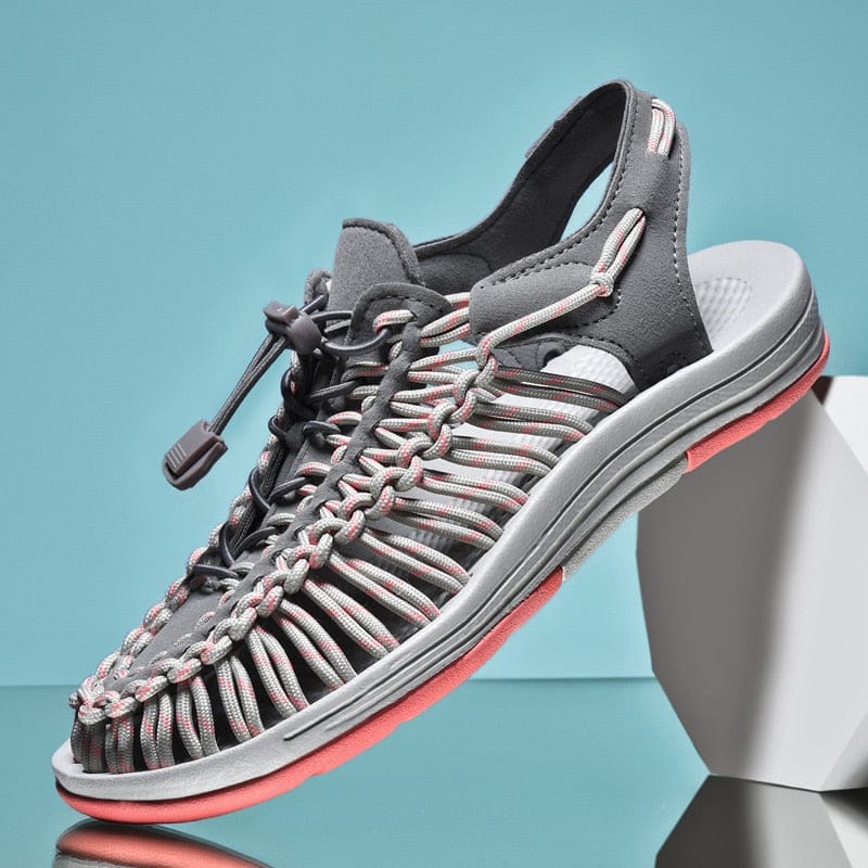 Grey and pink cord sandal with a toggle lace and open sides.