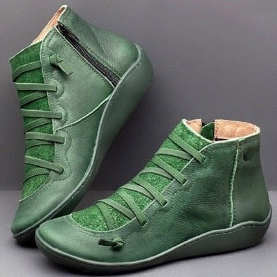 Green ankle boots with front laces, side zips and light-coloured lining.
