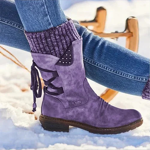 Purple knit-cuff boots with hanging side ties, shown on snow.
