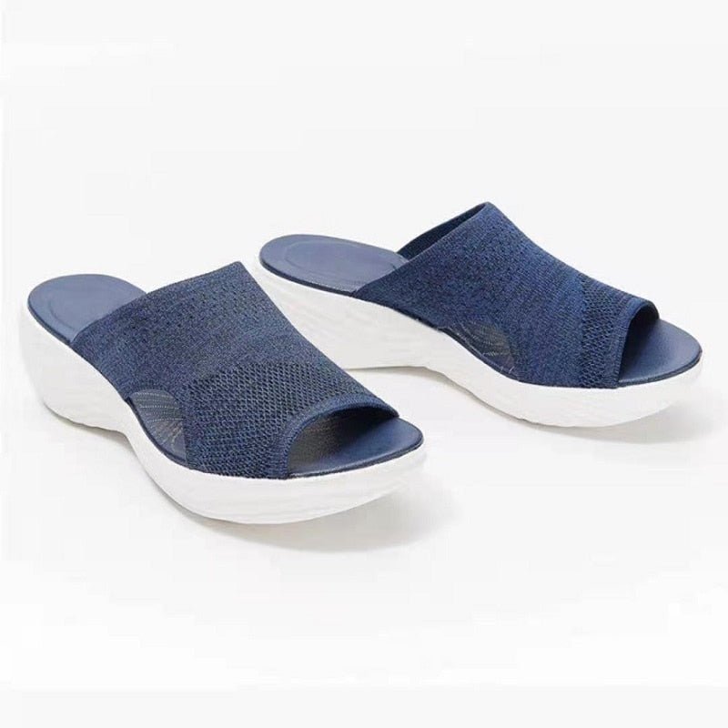 Pair of blue Vigar sandals with open toes and heels.