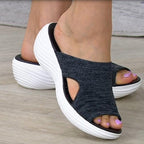 Black Vigar slide sandals worn with thick white soles.