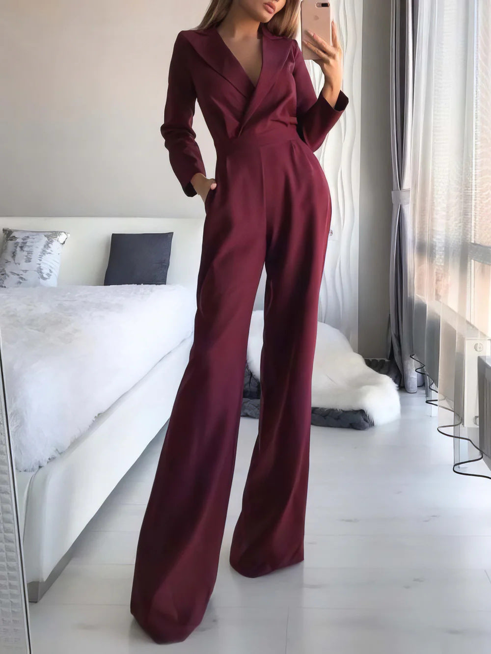 Dark red jumpsuit with lapels and wide legs.