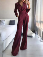 Dark red jumpsuit with lapels and wide legs.