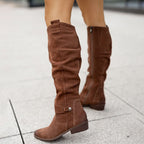 Brown knee-high boots with gathered shafts, ankle straps and low heels.