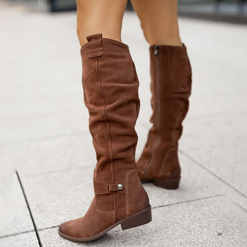 Brown knee-high boots with gathered shafts, ankle straps and low heels.