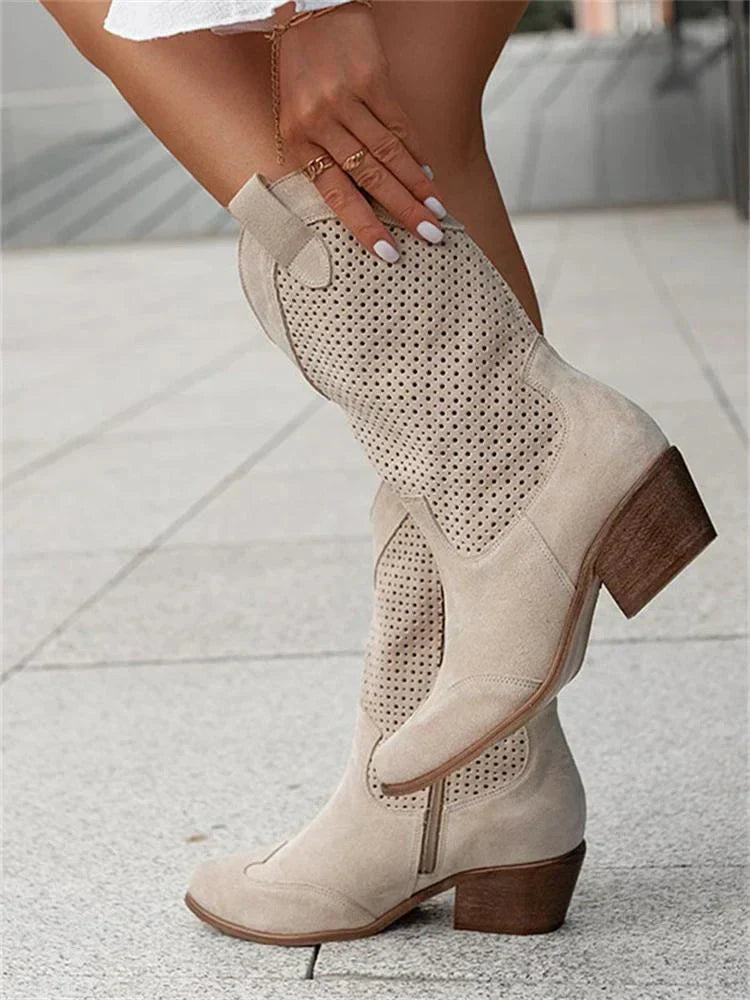 Beige western boots with side zips and block heels.