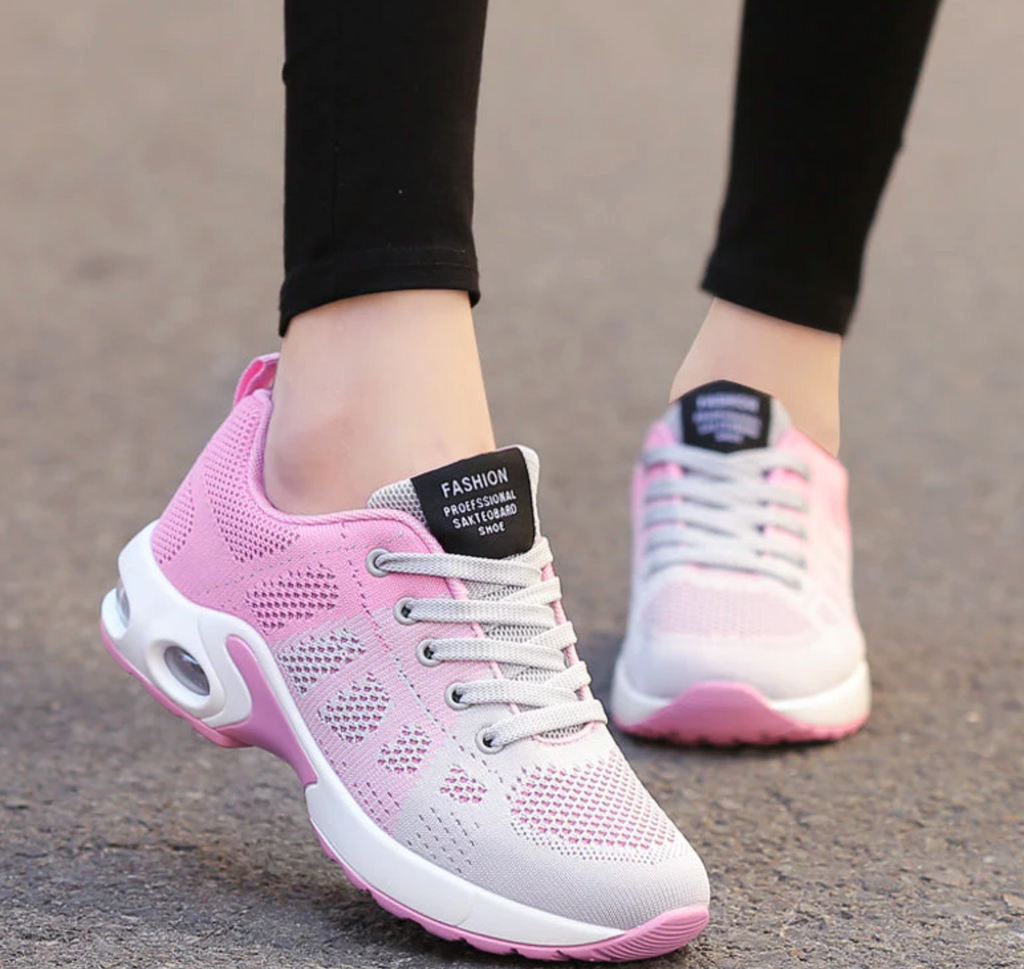 Pink and pale grey trainers with contrasting white laces.