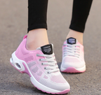 Pink and pale grey trainers with contrasting white laces.