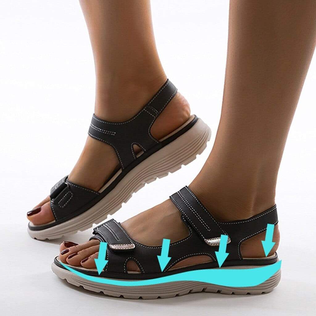 Dark blue sandals with a turquoise source graphic along the footbed.