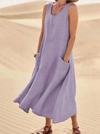 Light purple sleeveless dress with a rounded neckline and patch pockets.