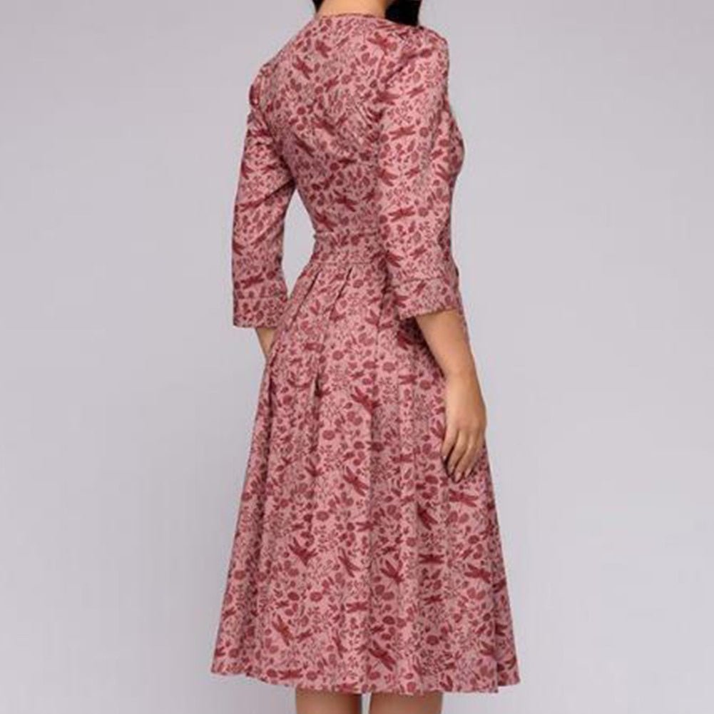 Rear view of the pink patterned midi dress.