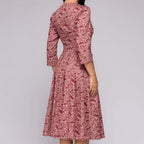 Rear view of the pink patterned midi dress.
