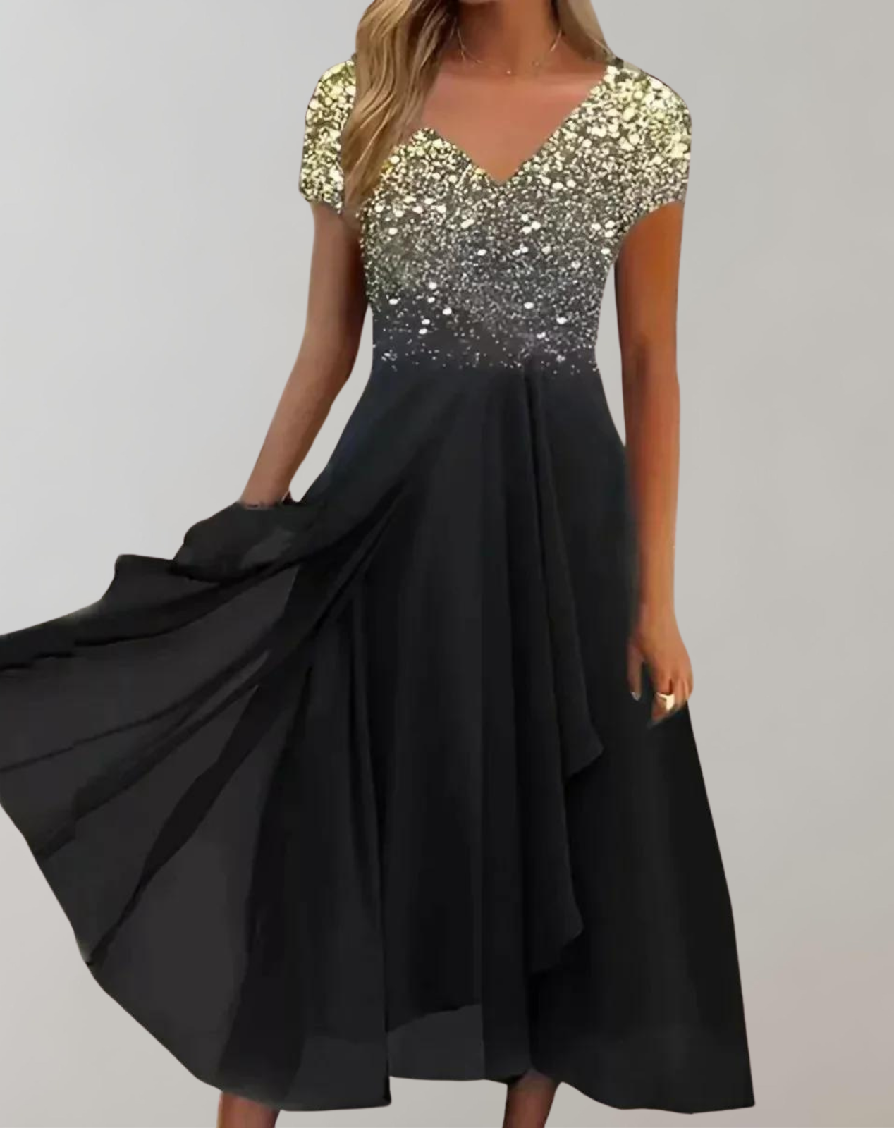 Gold sparkling V-neck top with a draped black skirt.