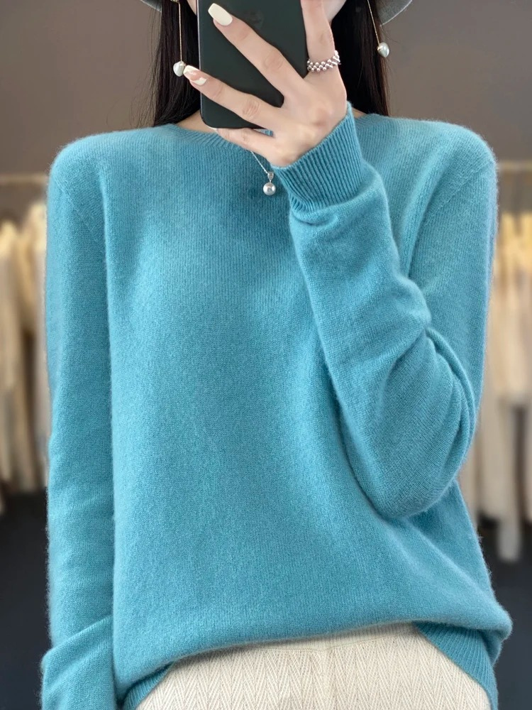Turquoise plain jumper with long sleeves and a ribbed neckline.