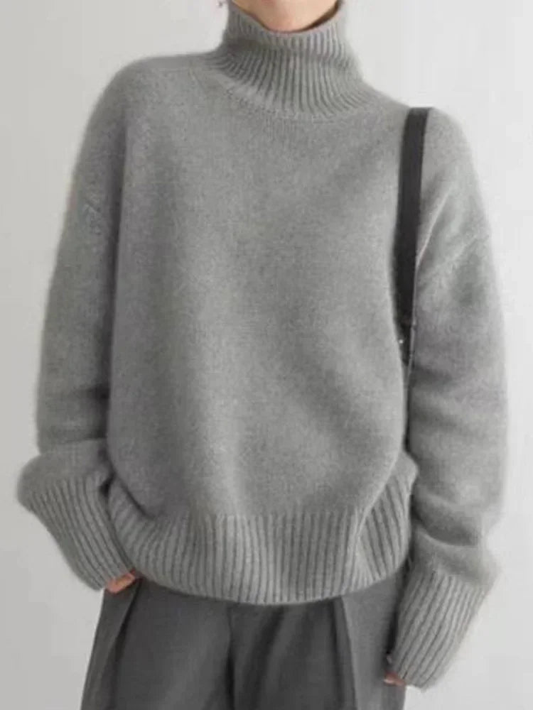 Front view of a grey roll-neck sweater with ribbed cuffs and hem.