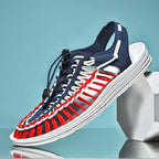 Blue, red and white cord sandal with an open heel and toggle lace.