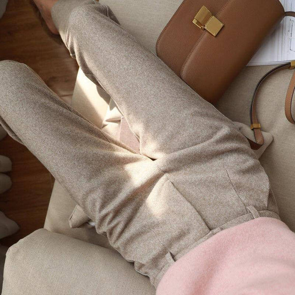 Light neutral trousers shown while seated.