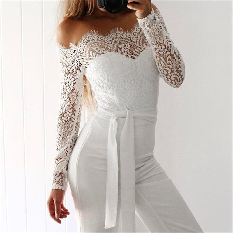 White off-shoulder jumpsuit with sheer lace sleeves and a tied waist.