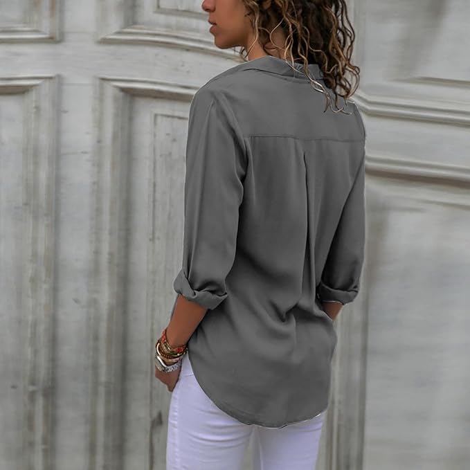 Grey blouse worn from the back with a curved hem.